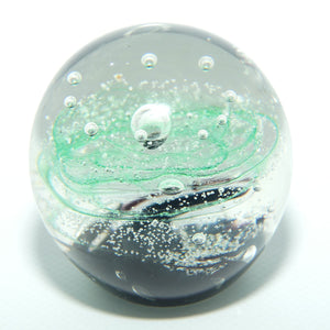 Controlled bubble within Green Swirl paperweight
