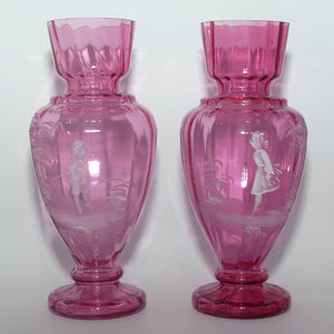 Cranberry Mary Gregory pair of vases depicting a boy with a walking cane and a girl on tip toes