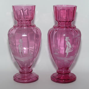 Cranberry Mary Gregory pair of vases depicting a boy with a walking cane and a girl on tip toes