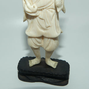 Japanese Carved Ivory figure of an Elder Fisherman with Catch