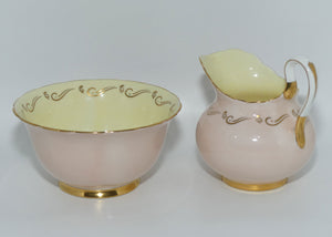 Tuscan Fine English Bone China Pink and Gilt Swirl milk and sugar | Fancy handle | Yellow Interior