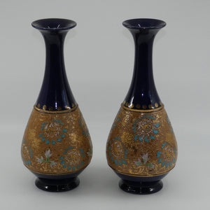 doulton-slaters-stoneware-pair-of-narrowneck-bulbous-vases-with-blue-white-green-enamelling-and-gilt-highlights-stamped-672