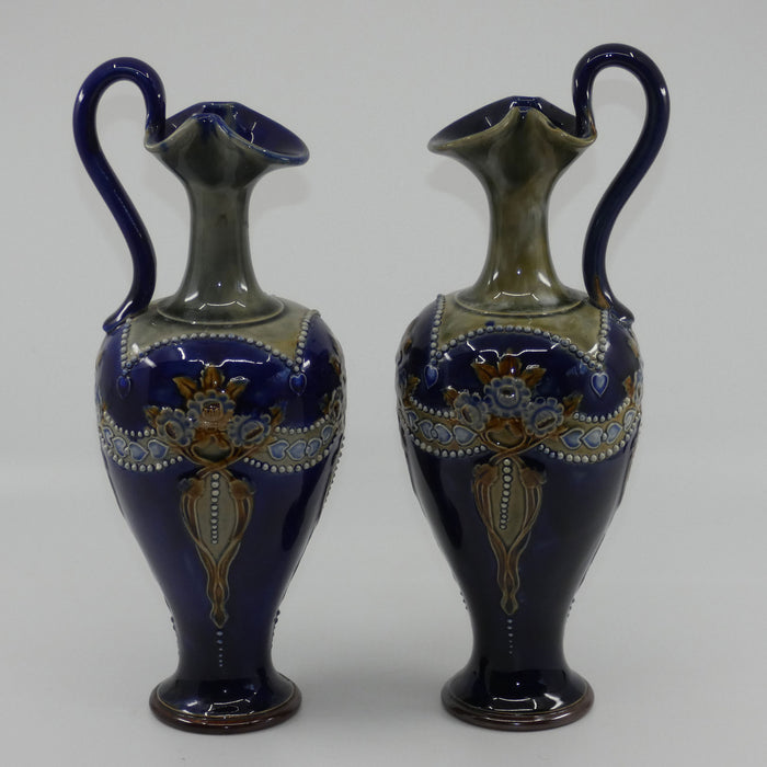 Royal Doulton pair of stoneware ewers with applied flowers, hearts and dots (stamped 7018)