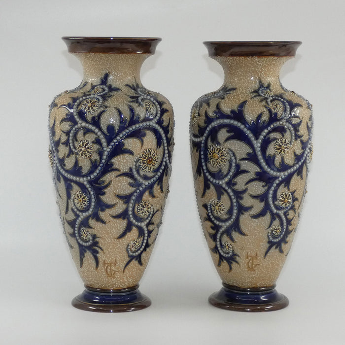 Royal Doulton stoneware George Tinworth pair of bulbous centrepiece vases with applied baguette beads and foliage